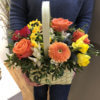 Корзинка с оранжевыми хризантемами, розами, тюльпанами, хризантемами и декоративной зеленью