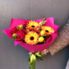 Букет с герберой, альстромерией, тюльпанами, розой и декоративной зеленью в упаковке